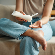 woman applying cream to her feet